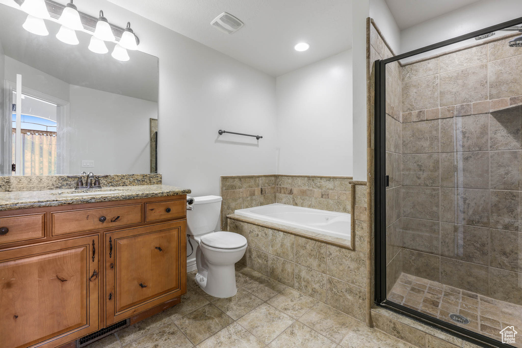Bathroom featuring a shower stall, vanity, a garden tub, and tile patterned floors