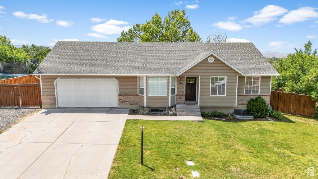 View of front of property featuring brick siding, an attached garage, concrete driveway, and a shingled roof