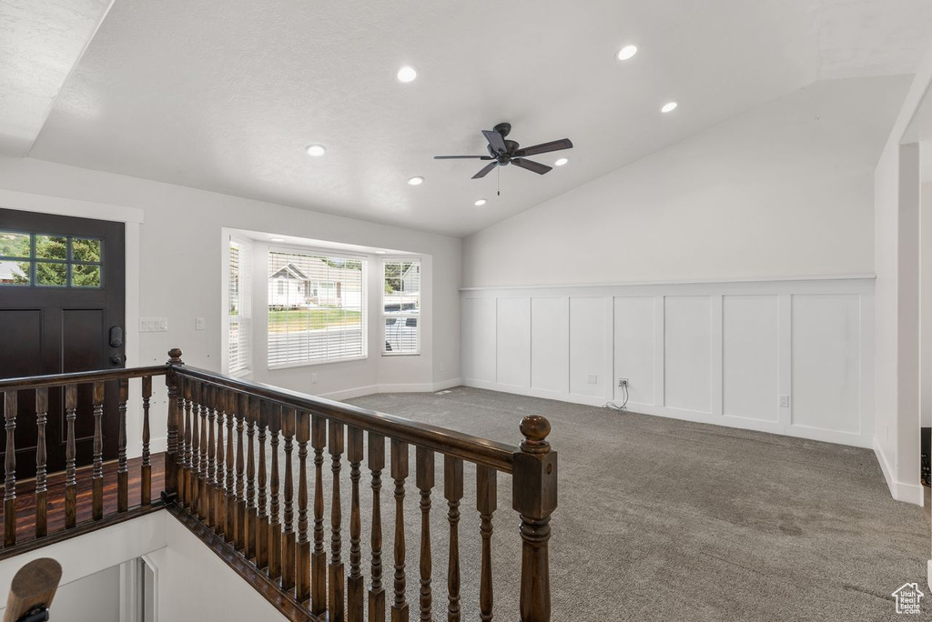 Foyer with recessed lighting, lofted ceiling, a ceiling fan, and carpet flooring