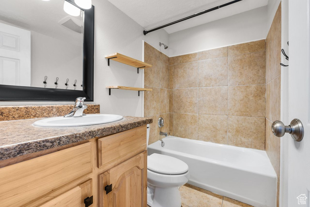 Bathroom with vanity, washtub / shower combination, and tile patterned floors