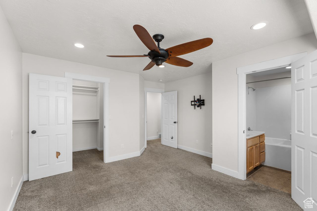 Unfurnished bedroom featuring carpet flooring, a spacious closet, recessed lighting, connected bathroom, and a closet