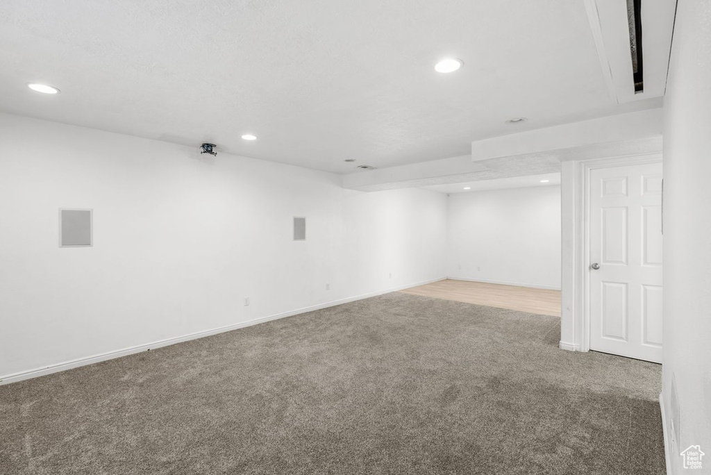 Finished basement with carpet floors and recessed lighting