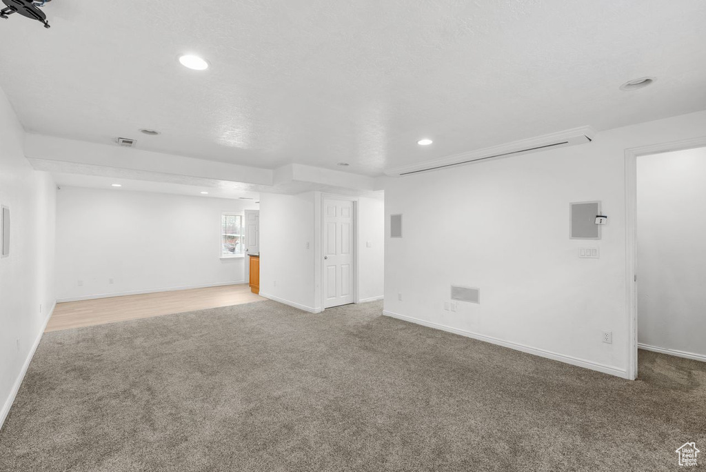 Unfurnished living room featuring carpet flooring and recessed lighting