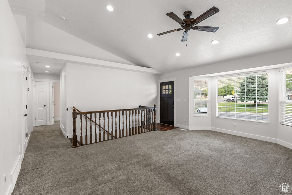 Carpeted empty room featuring recessed lighting, lofted ceiling, and ceiling fan