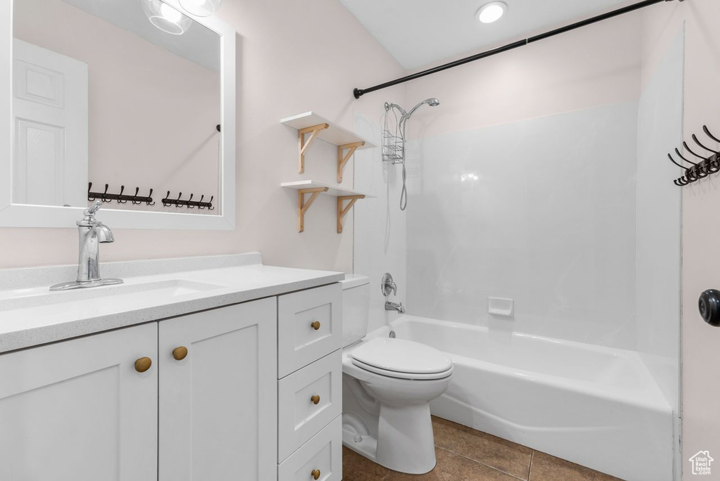 Full bathroom featuring shower / bath combination, vanity, and tile patterned floors