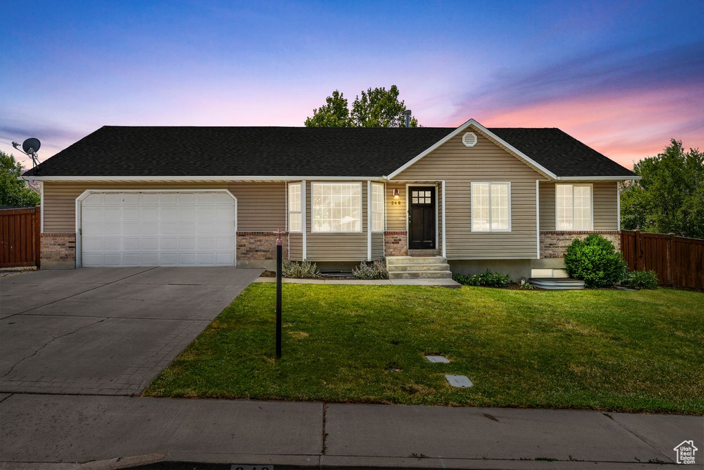 Ranch-style house with a garage, concrete driveway, brick siding, entry steps, and a shingled roof