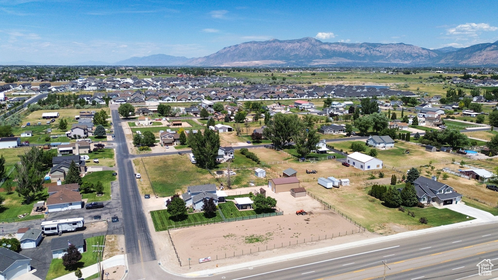 Aerial view of property's location with a mountain backdrop and nearby suburban area
