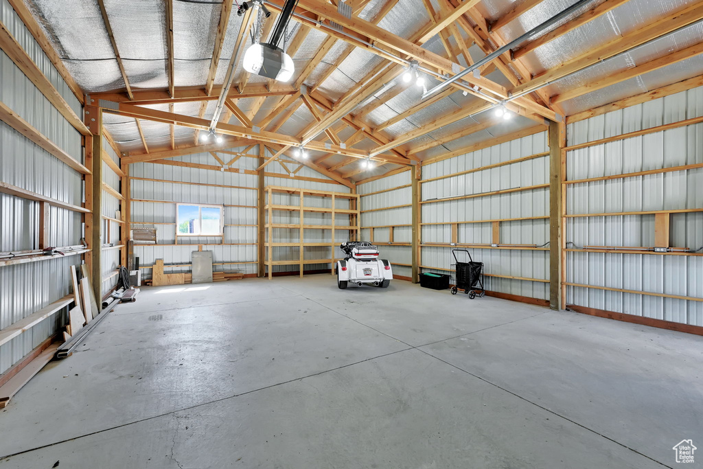 Garage with a garage door opener and metal wall