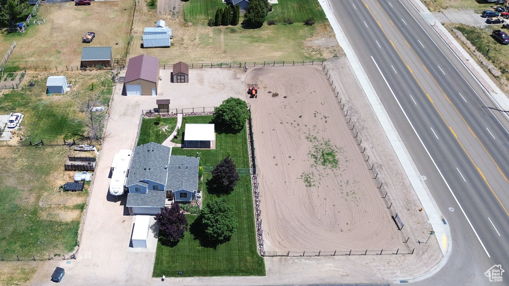 Aerial view of property and surrounding area featuring a major roadway