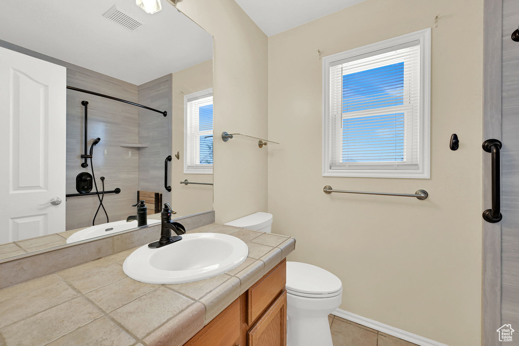 Full bathroom with vanity, a shower, and tile patterned floors