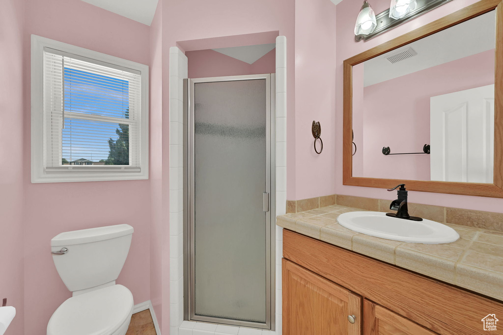 Bathroom featuring vanity and a shower stall