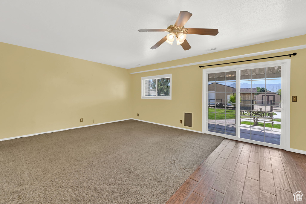 Spare room with ceiling fan and dark wood-style flooring