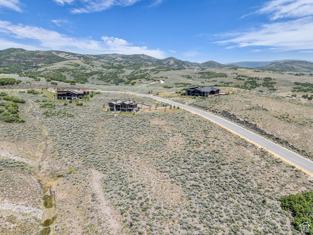 Aerial view of property and surrounding area featuring mountains