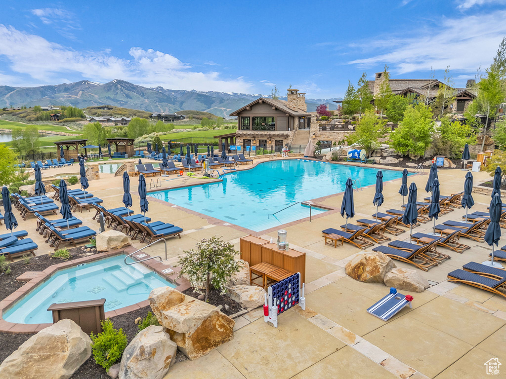 Community pool with a mountain view and a patio