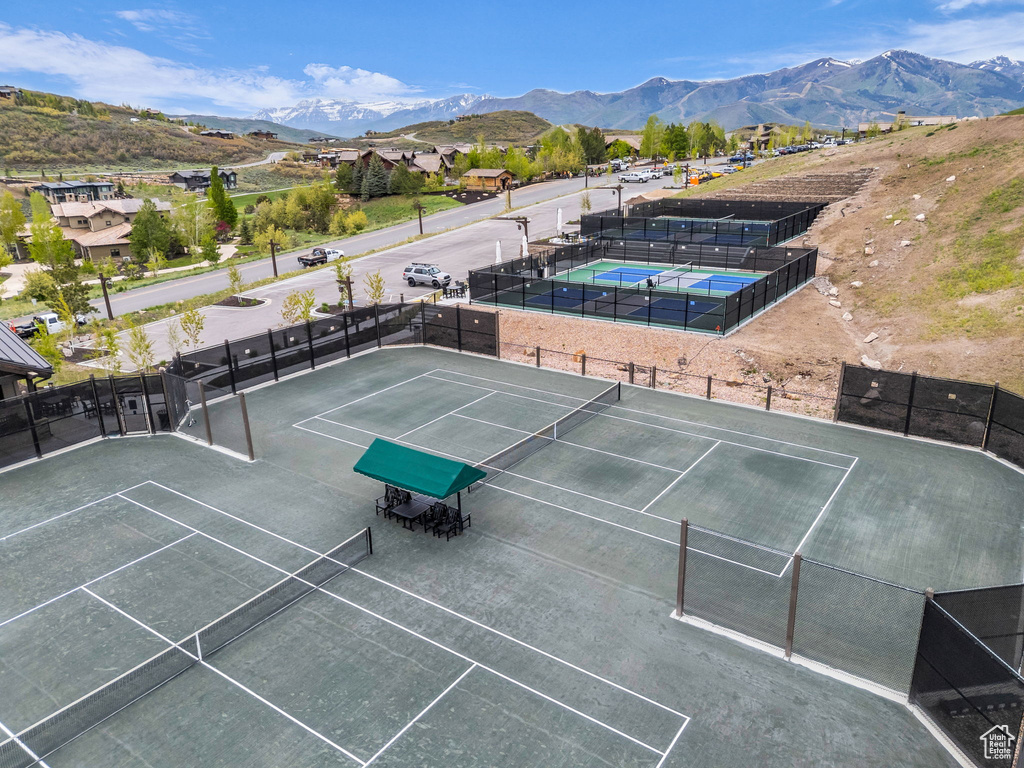 View of tennis court with a mountain view
