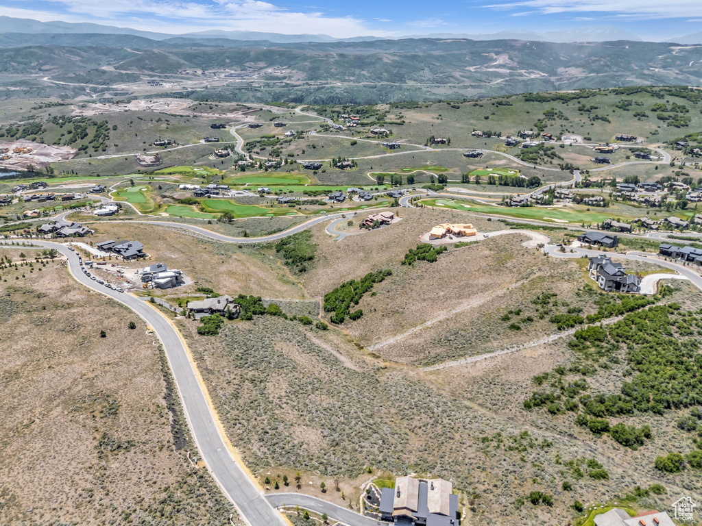 Aerial view of property and surrounding area with mountains