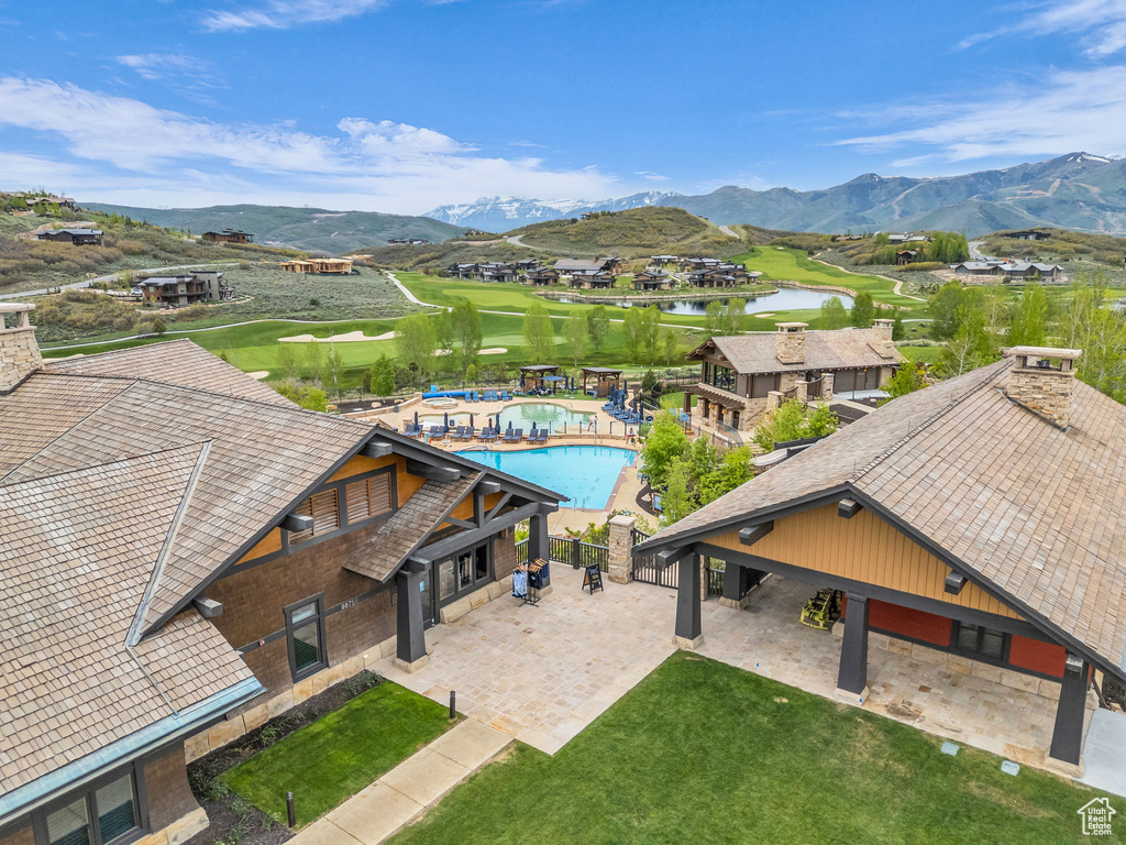 Drone / aerial view of a water and mountain view and a pool area