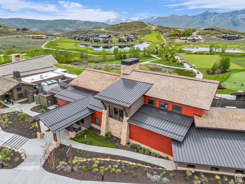 Aerial view of residential area with a water and mountain view and a golf club