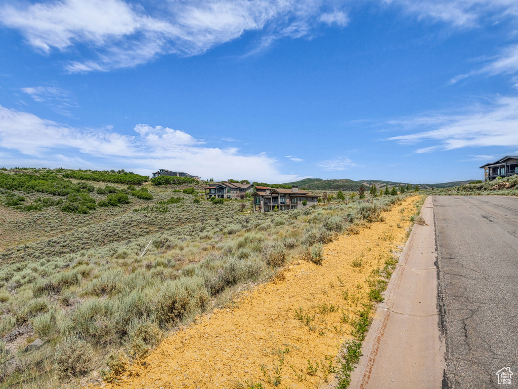 View of asphalt road with curbs