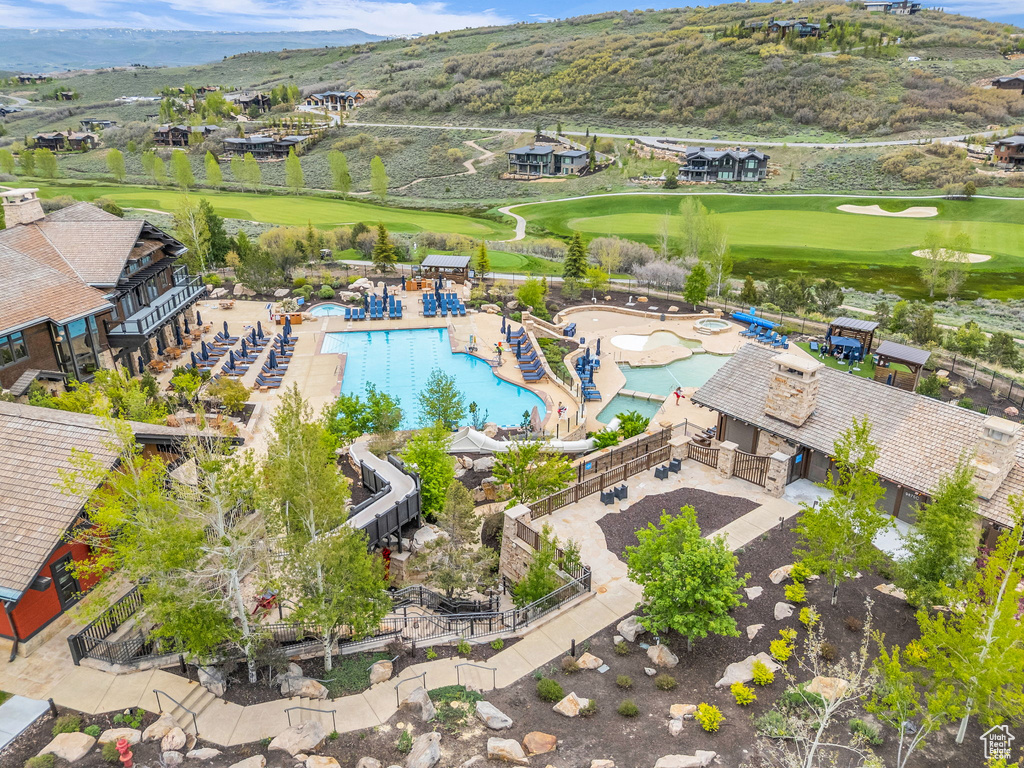 Drone / aerial view of a local golf course and a mountainous background
