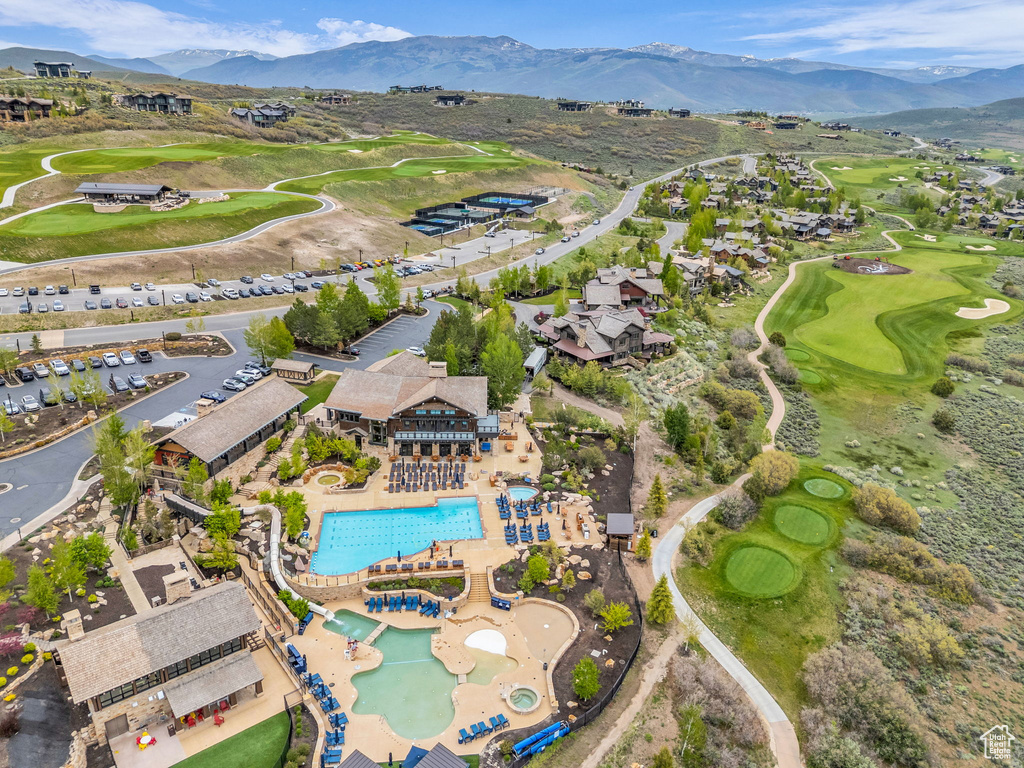 Drone / aerial view of a mountainous background and a golf club