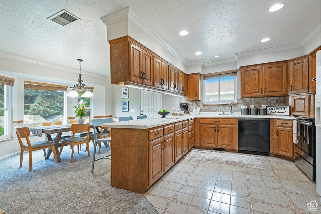 Kitchen with dishwasher, a peninsula, brown cabinetry, a textured ceiling, and tasteful backsplash