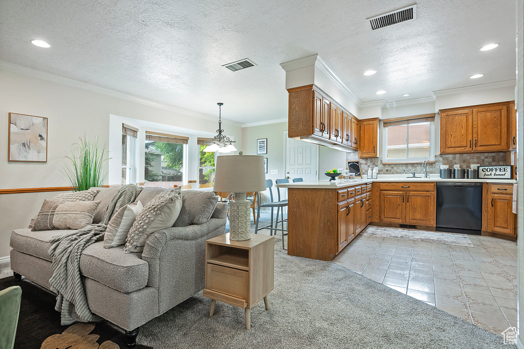 Kitchen with dishwasher, a peninsula, brown cabinetry, tasteful backsplash, and ornamental molding
