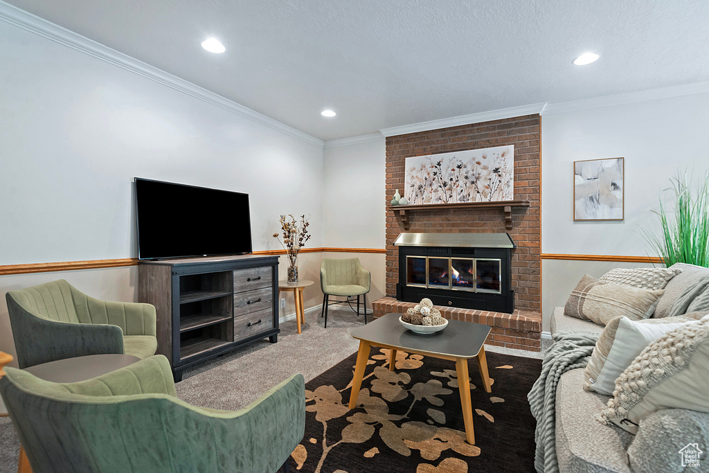 Carpeted living room featuring a brick fireplace, crown molding, and recessed lighting