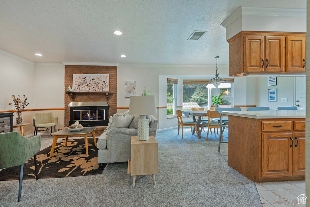 Living area with light carpet, a fireplace, crown molding, recessed lighting, and a textured ceiling