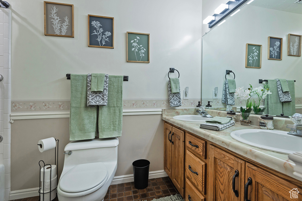 Full bath featuring double vanity and a shower