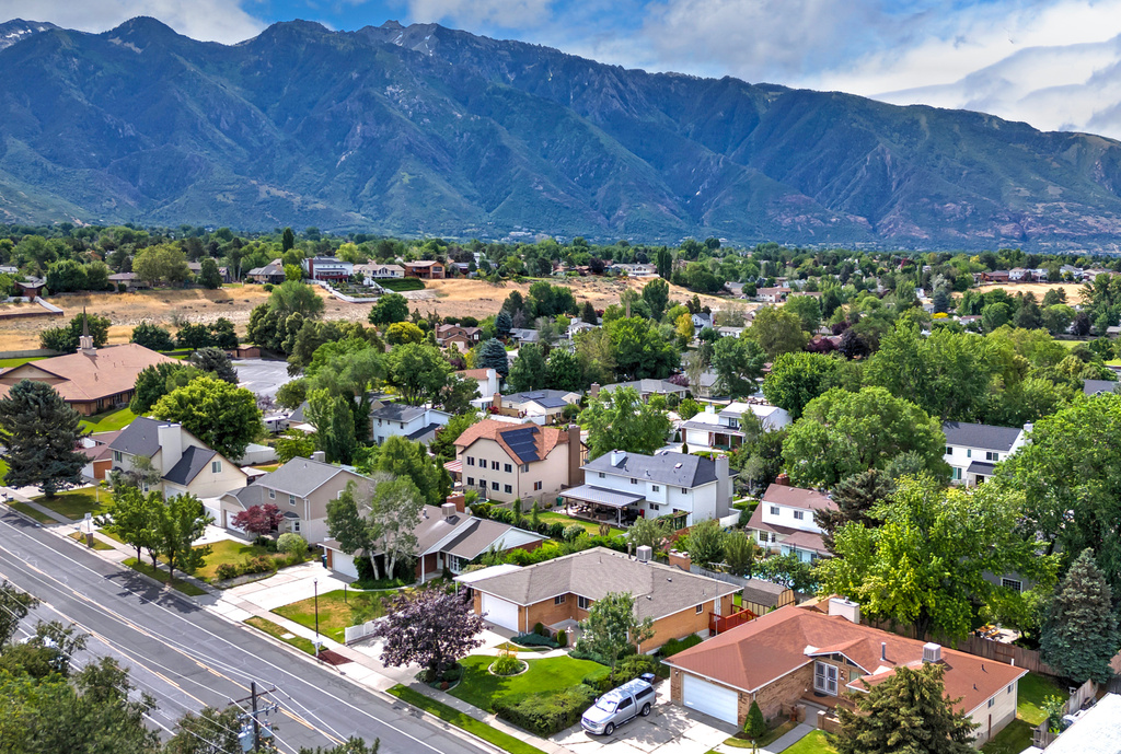 Aerial perspective of suburban area featuring a mountainous background