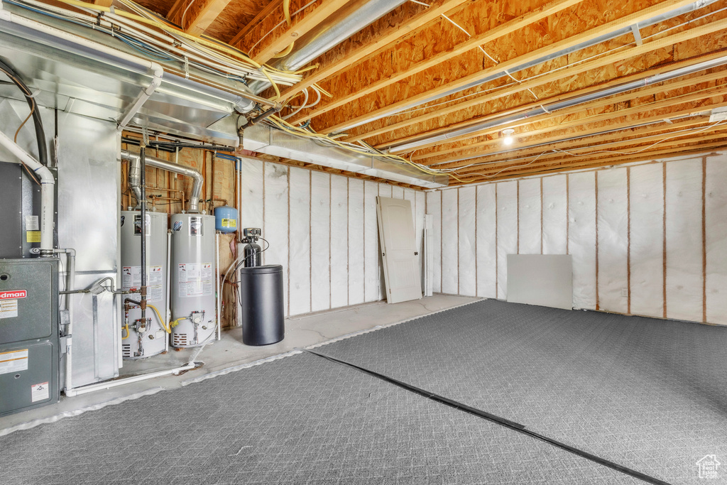 Unfinished basement with water heater, a water softener system, and heating unit