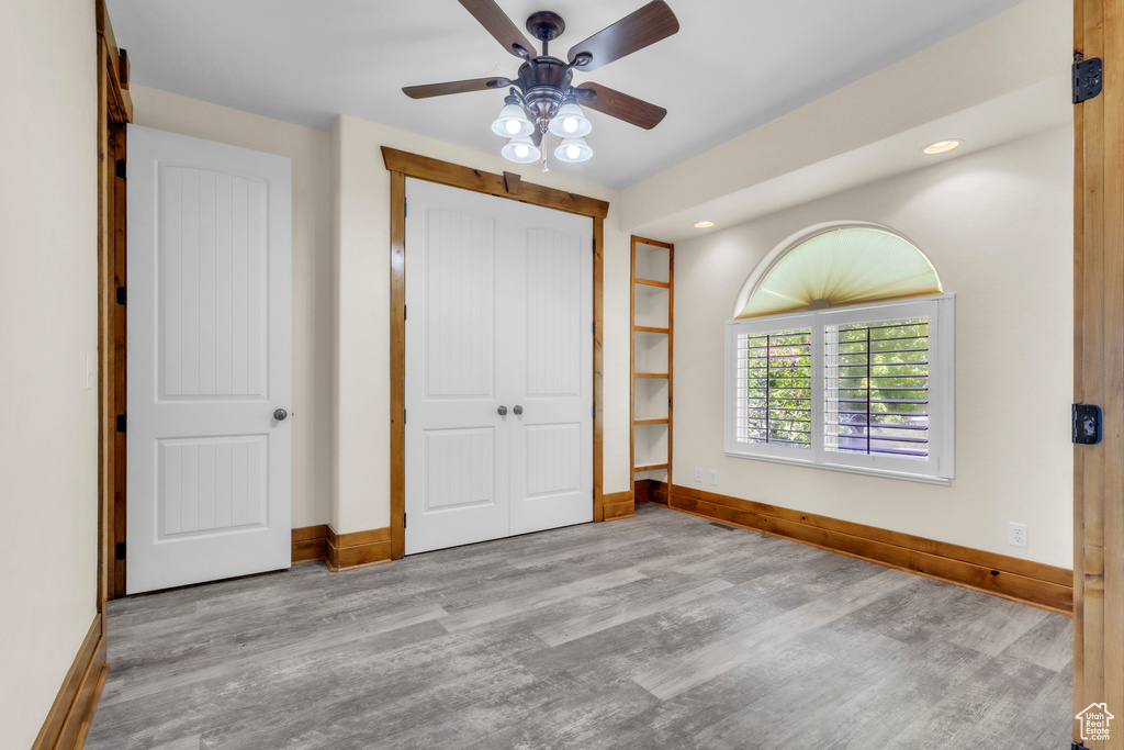 Unfurnished bedroom with wood finished floors, a closet, recessed lighting, and ceiling fan
