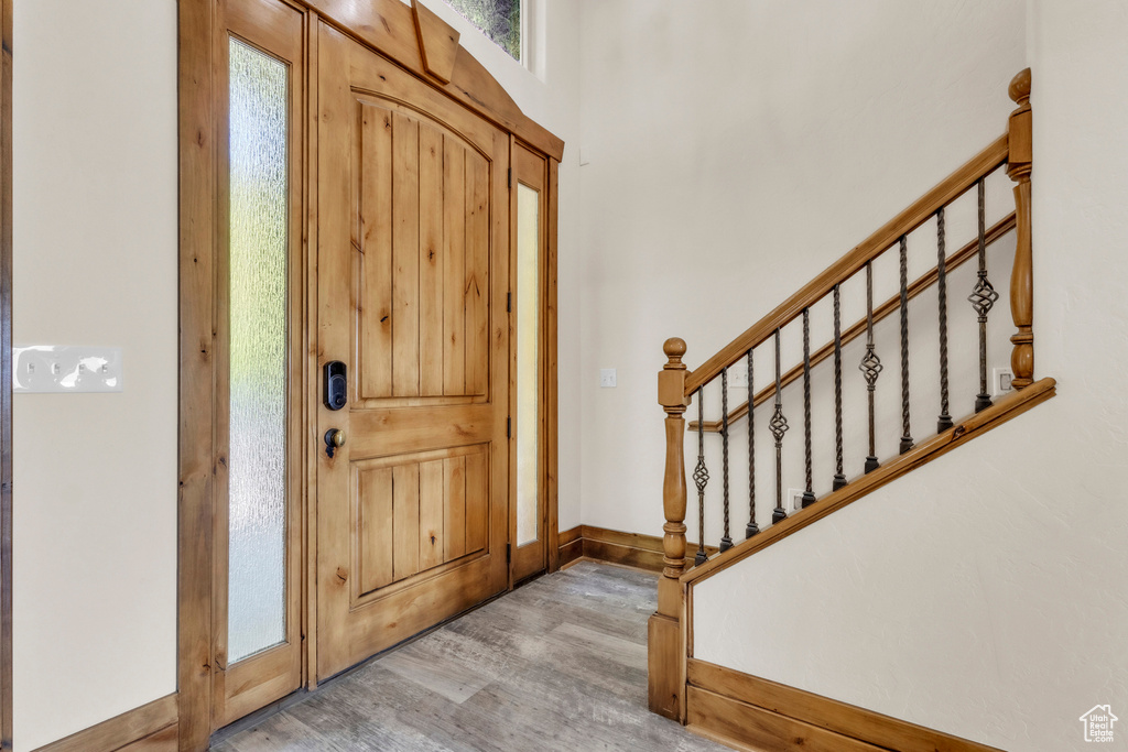 Foyer entrance featuring light wood finished floors and stairs