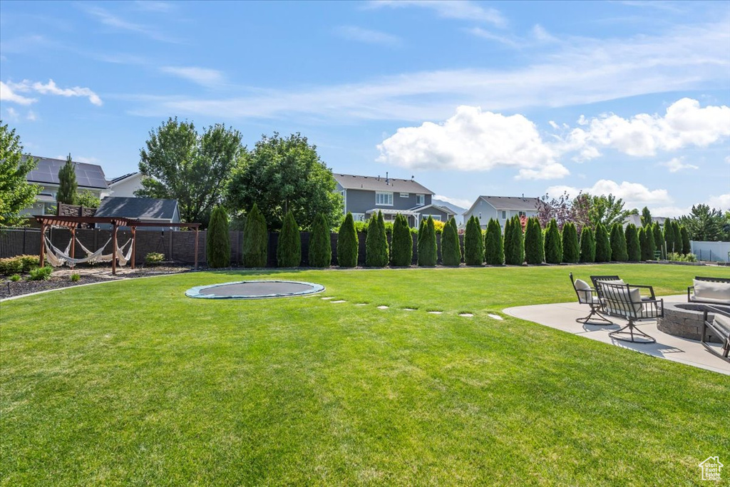 View of yard featuring a patio area and a fire pit