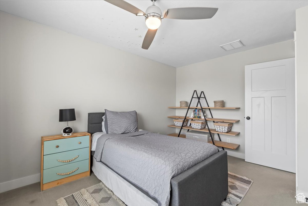 Bedroom featuring light carpet and ceiling fan