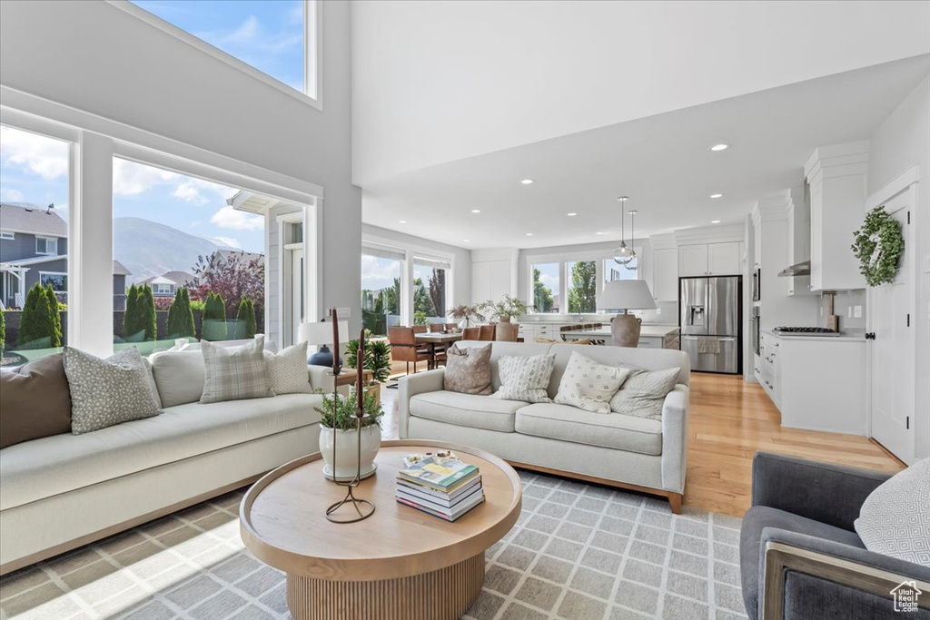 Living room featuring light wood-type flooring, recessed lighting, and a mountain view