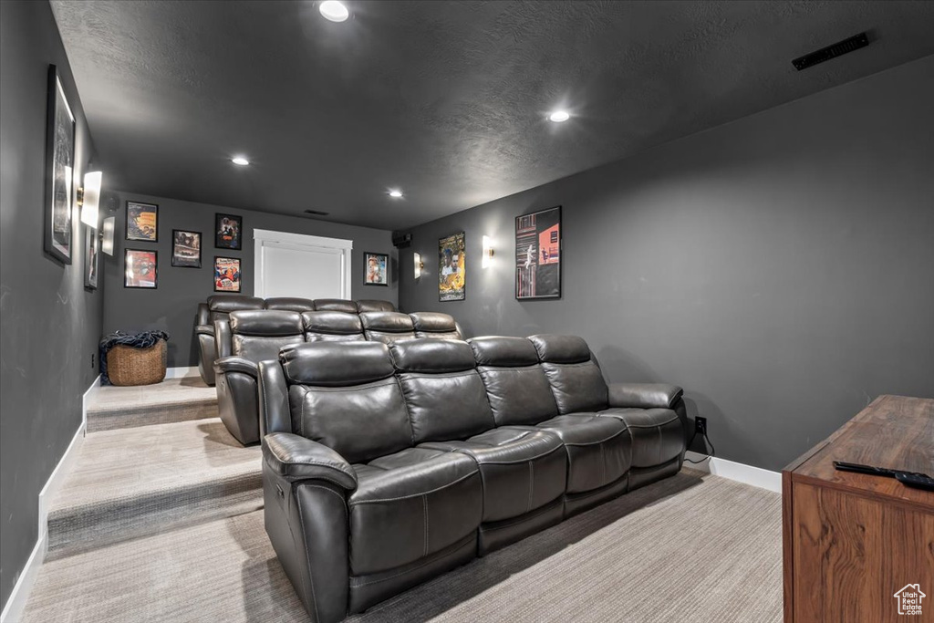 Carpeted cinema room with baseboards and recessed lighting