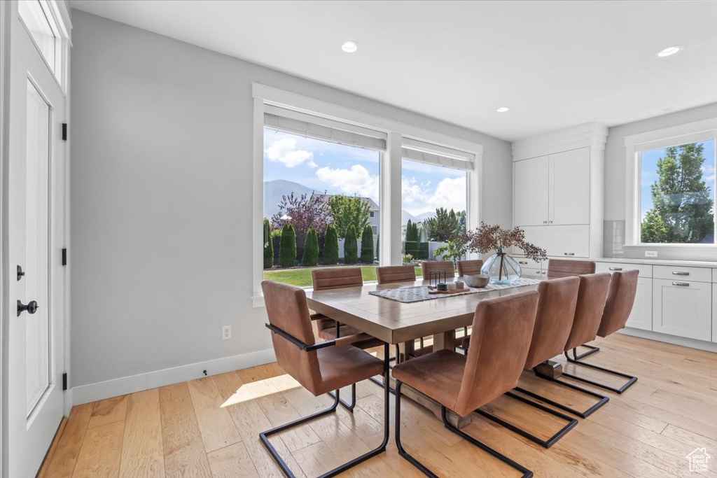 Dining area featuring plenty of natural light, light wood-style floors, and recessed lighting