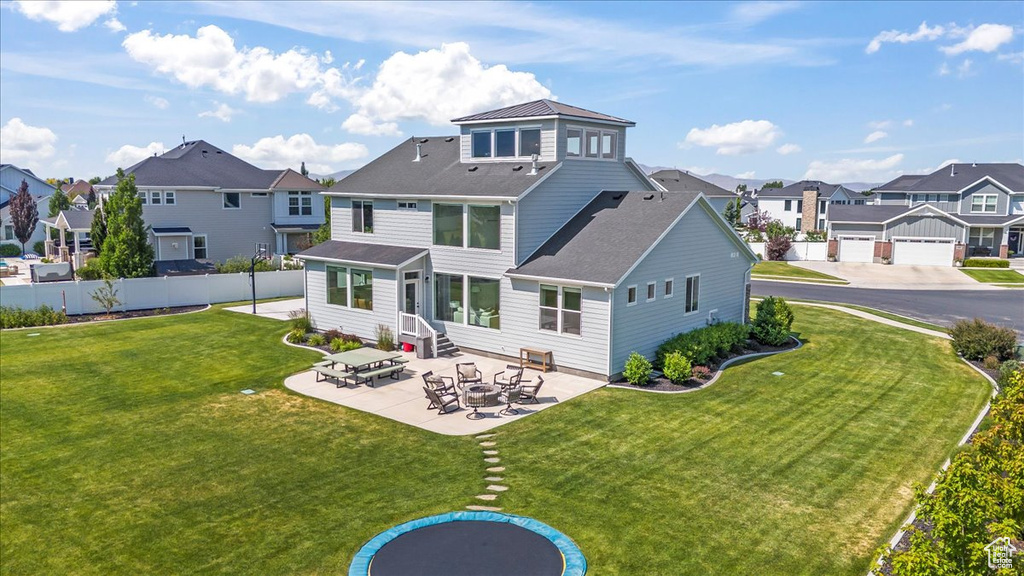 Rear view of house featuring a residential view, entry steps, a patio, and roof with shingles