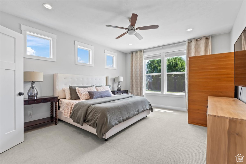 Bedroom with light colored carpet, recessed lighting, and a ceiling fan