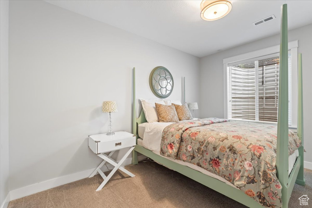 Carpeted bedroom with baseboards