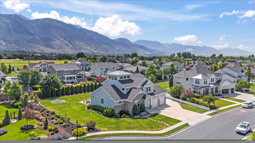 Aerial perspective of suburban area featuring a mountain backdrop