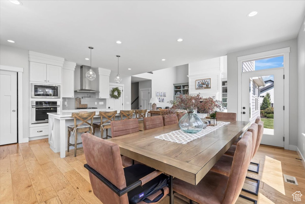 Dining area featuring light wood-type flooring and recessed lighting