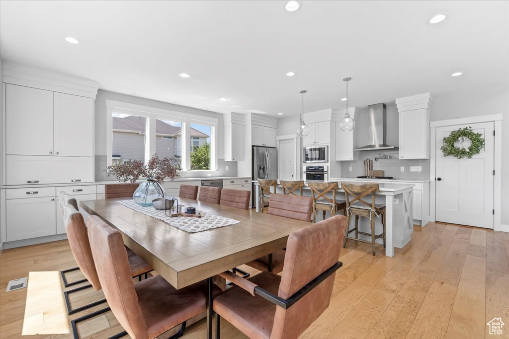 Dining area featuring light wood-type flooring and recessed lighting