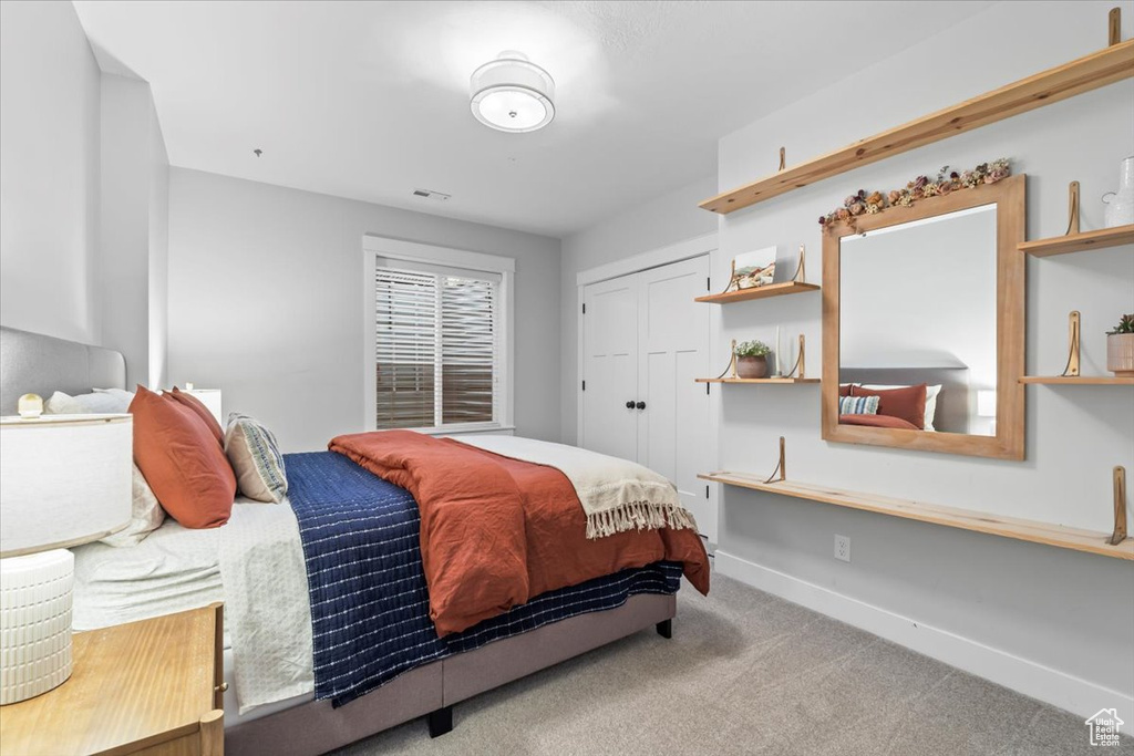 Bedroom featuring carpet floors and a closet