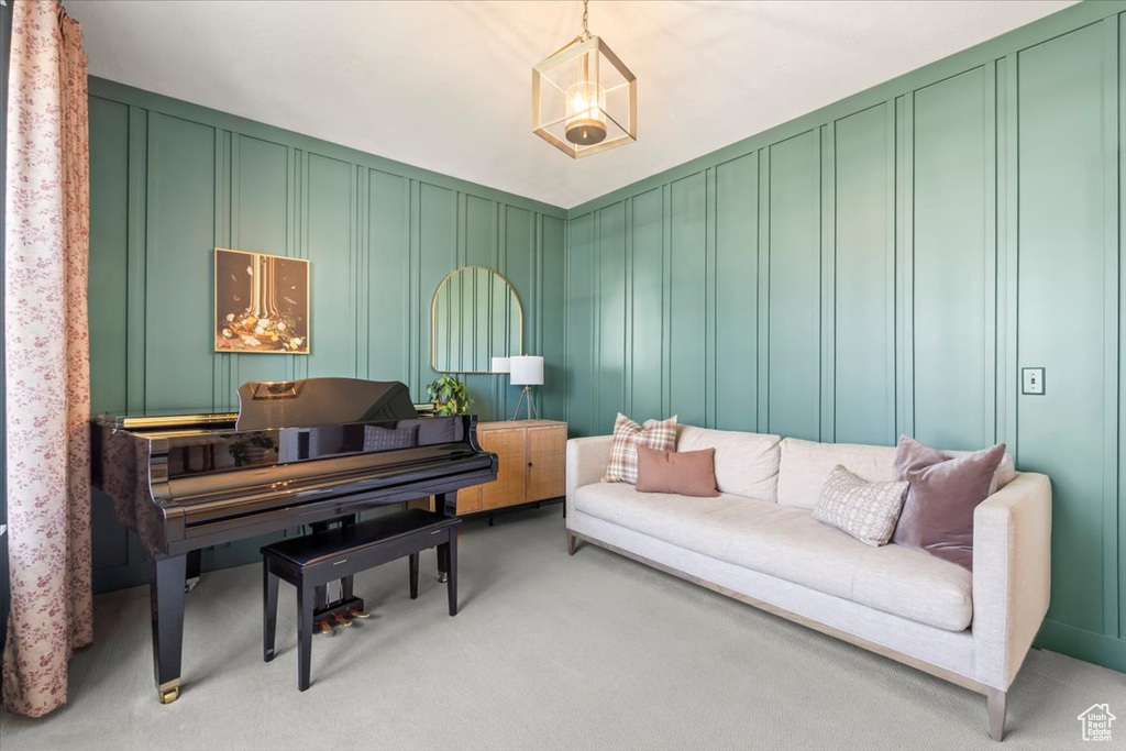 Sitting room with a decorative wall and light carpet