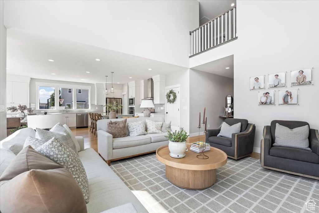 Living area with light wood-style floors and recessed lighting