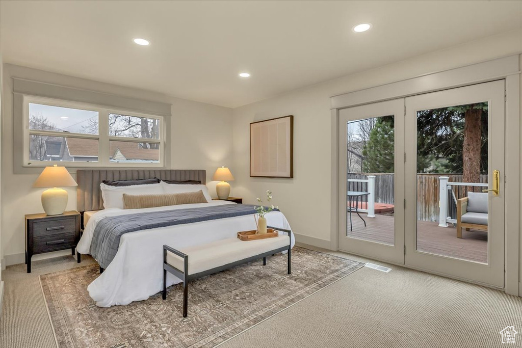 Bedroom featuring access to exterior, light colored carpet, and recessed lighting