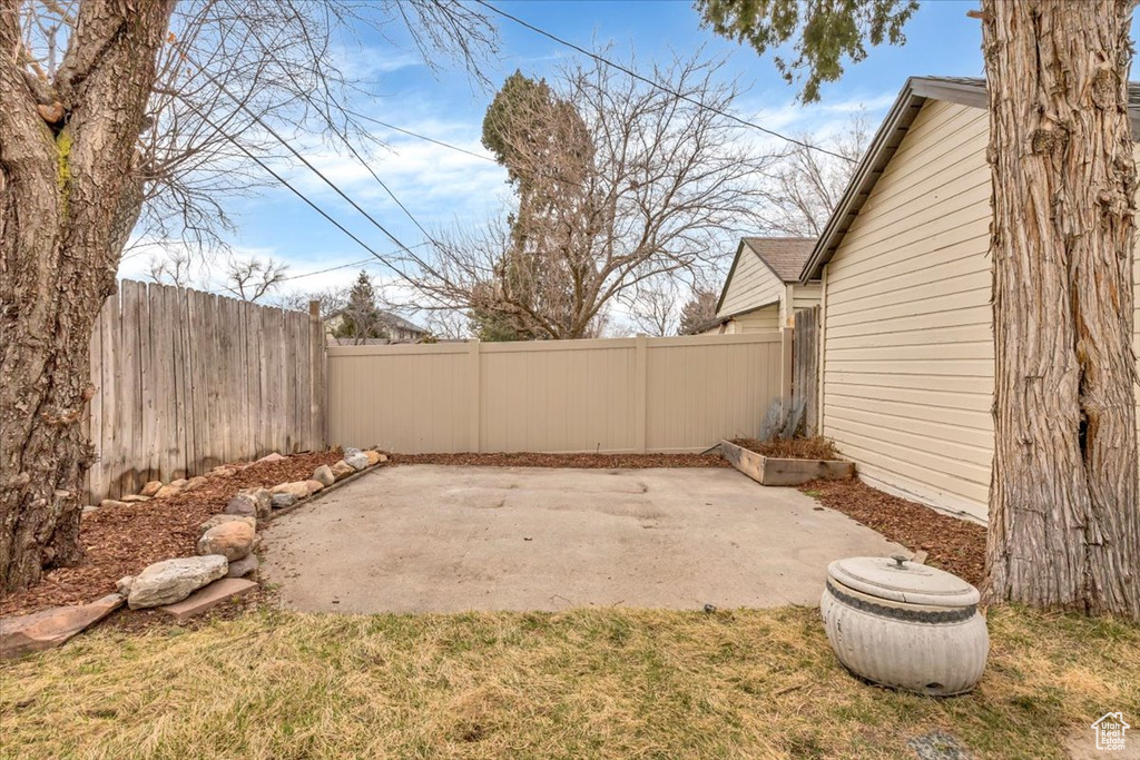 Fenced backyard featuring a patio